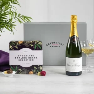Image showing champagne and praline hearts gift box with contents laid out in front
