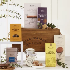 Image showing the contents of the chocolate hamper in wooden crate laid out on a kitchen table